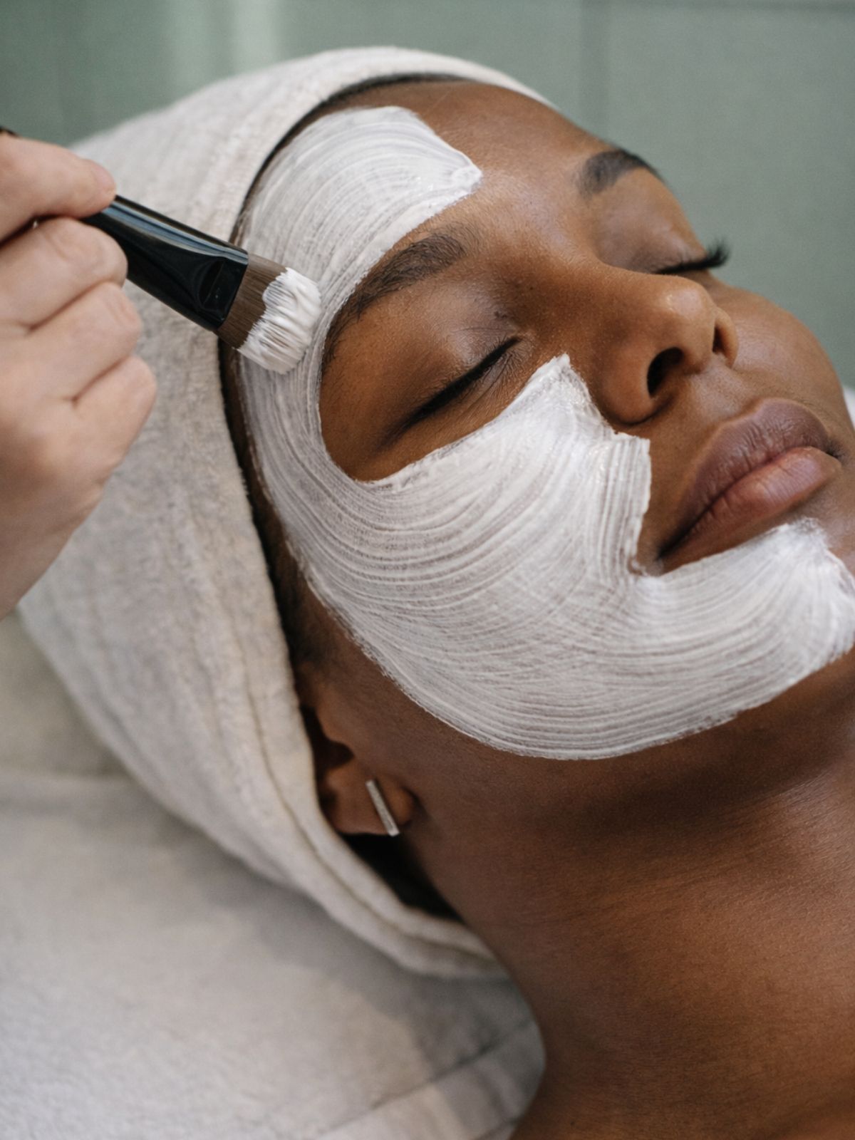 Professional Facial Treatment in Springs Close-up of professional facial mask application on African woman at medical aesthetic clinic in Springs.